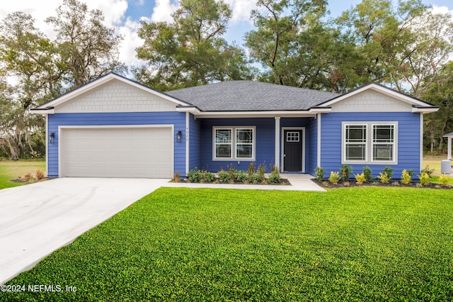 single story home featuring a garage and a front yard