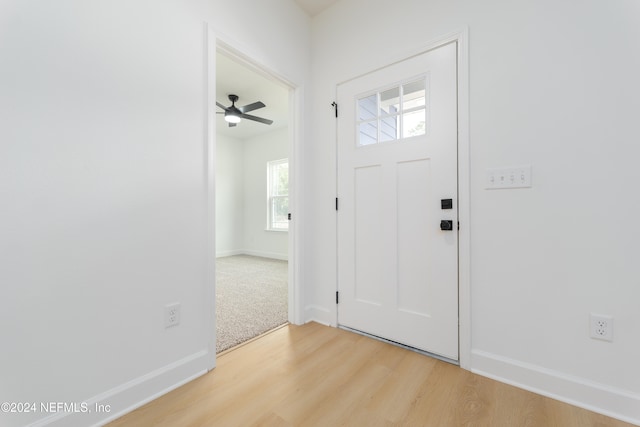 entrance foyer featuring a wealth of natural light, ceiling fan, and light hardwood / wood-style flooring