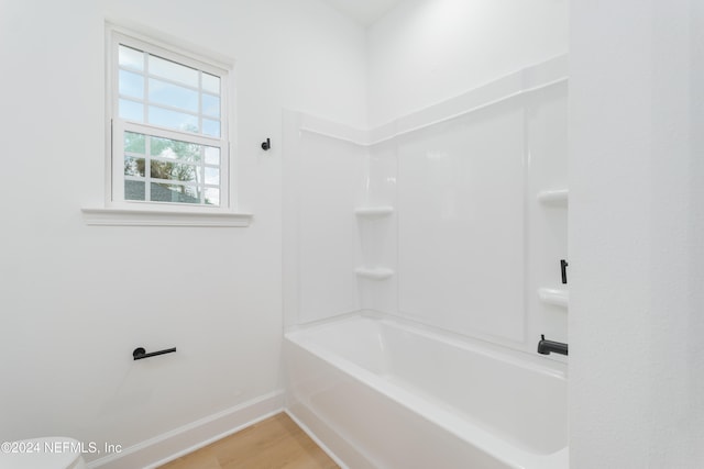 bathroom featuring shower / bath combination and hardwood / wood-style flooring