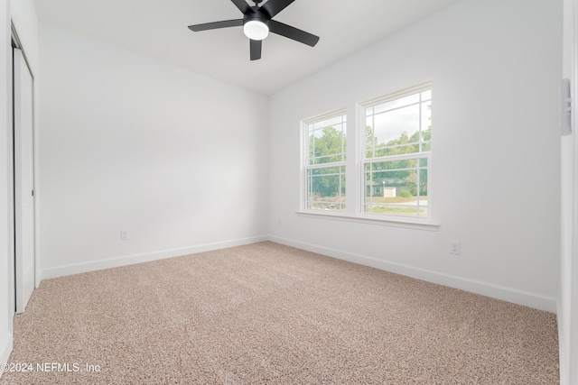 unfurnished room featuring carpet and ceiling fan