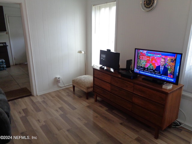 interior space with hardwood / wood-style floors and wood walls