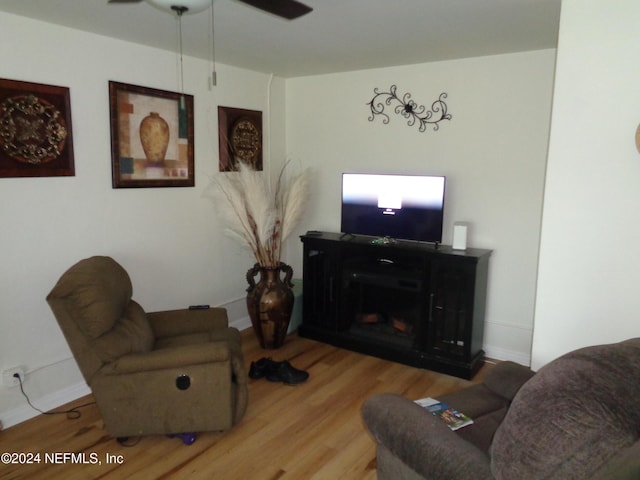 living room with wood-type flooring and ceiling fan