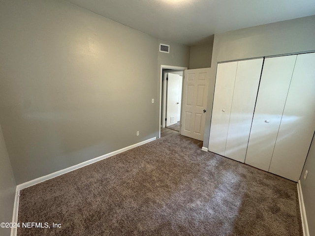 unfurnished bedroom featuring a closet and carpet flooring