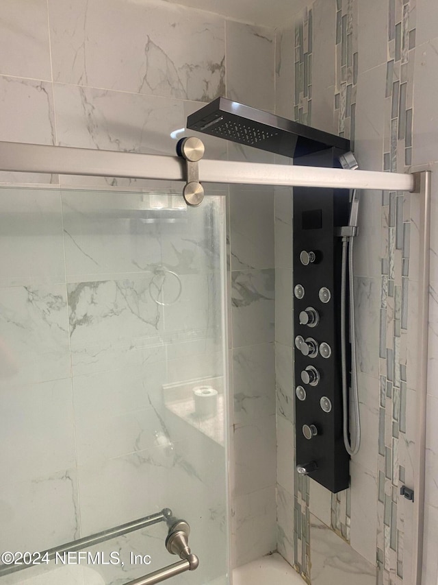 bathroom with a shower with shower door