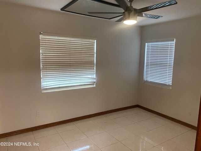 tiled empty room with ceiling fan