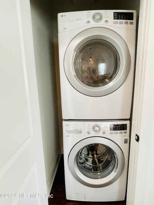 washroom with stacked washer / drying machine