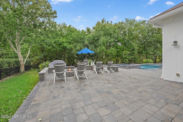 view of patio with a pool with hot tub