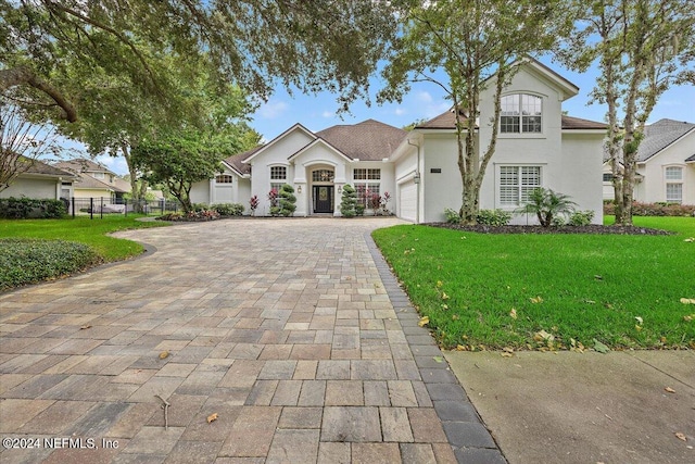 view of front of house with a garage and a front yard