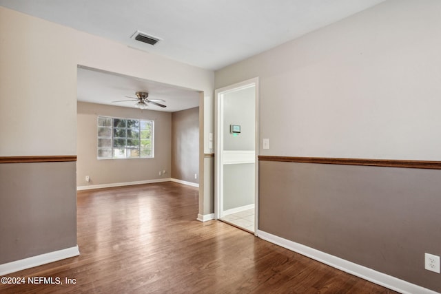 unfurnished room with ceiling fan and hardwood / wood-style flooring