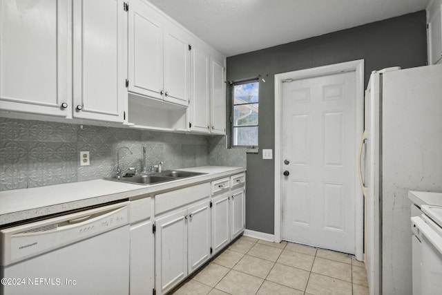6124 Sudbury Ave S, Jacksonville, FL 32210 - kitchen featuring white cabinetry, light tile patterned floors, a sink, and white appliances