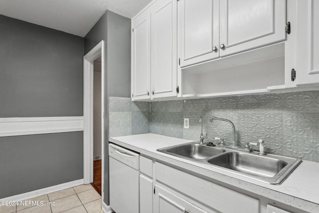 6124 Sudbury Ave S, Jacksonville, FL 32210 - kitchen with light tile patterned flooring, light countertops, white cabinetry, a sink, and white dishwasher