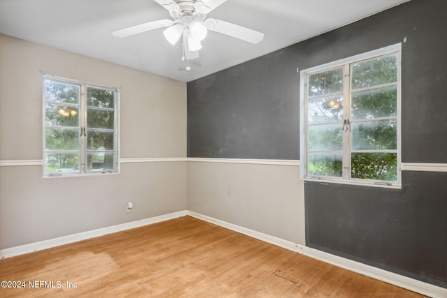 spare room with ceiling fan and hardwood / wood-style flooring