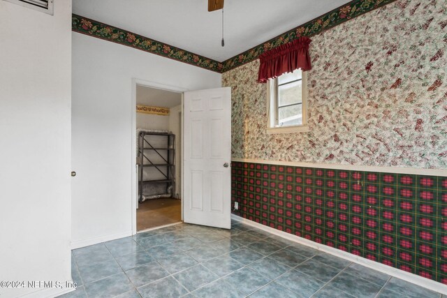 6124 Sudbury Ave S, Jacksonville, FL 32210 - unfurnished room with tile patterned floors, wainscoting, visible vents, baseboards, and wallpapered walls