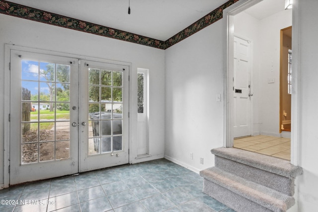 doorway to outside featuring light tile patterned floors and french doors