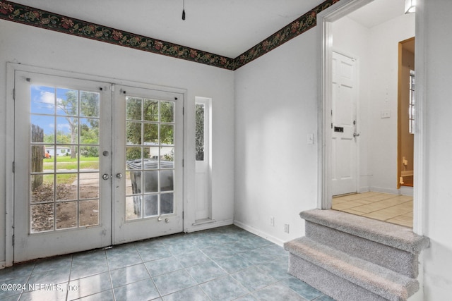 6124 Sudbury Ave S, Jacksonville, FL 32210 - doorway with french doors, tile patterned flooring, and baseboards
