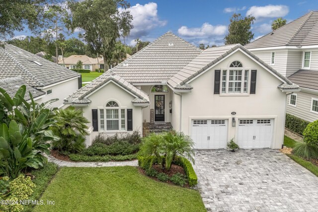 view of front of property with a garage and a front yard