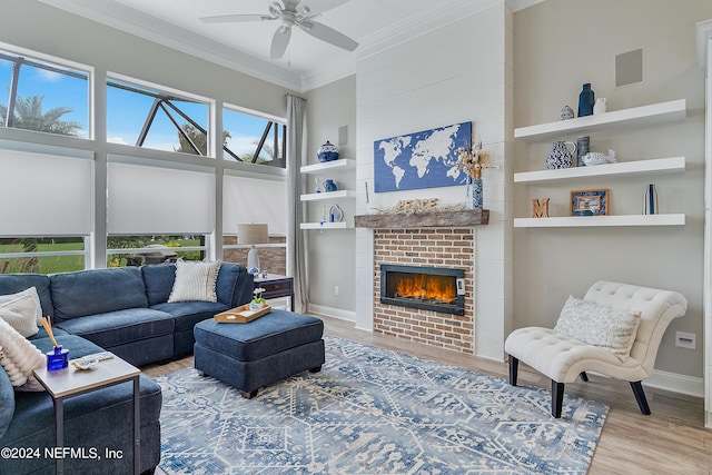 living room featuring ornamental molding, hardwood / wood-style floors, ceiling fan, and a fireplace