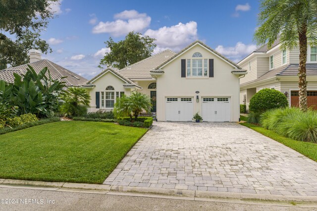 view of front of house with a front yard and a garage