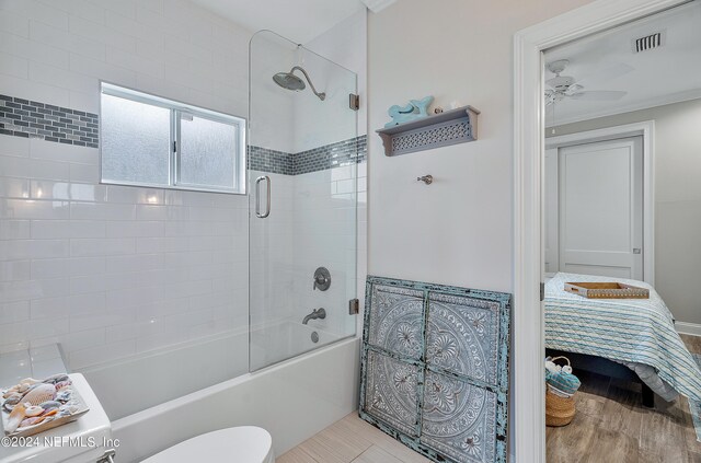 bathroom featuring wood-type flooring, ornamental molding, toilet, and ceiling fan