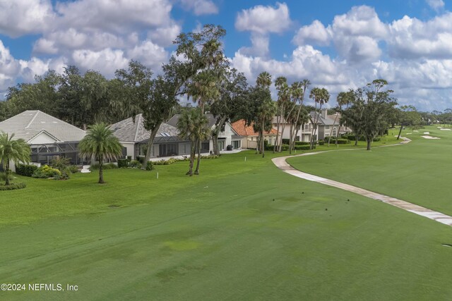 view of property's community with a lawn