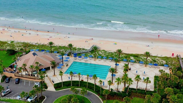 birds eye view of property featuring a water view and a beach view