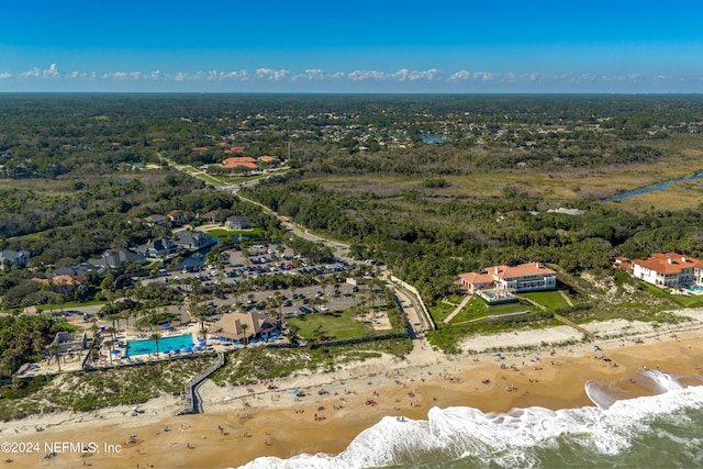 drone / aerial view featuring a water view and a view of the beach