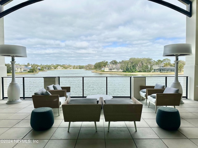 view of patio featuring a balcony and a water view