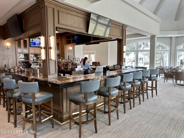 bar with beam ceiling and light carpet