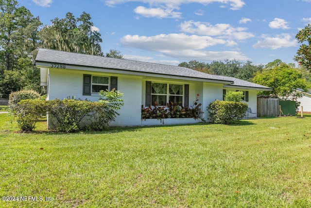 ranch-style house with a front lawn