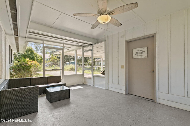 unfurnished sunroom featuring ceiling fan and a wealth of natural light