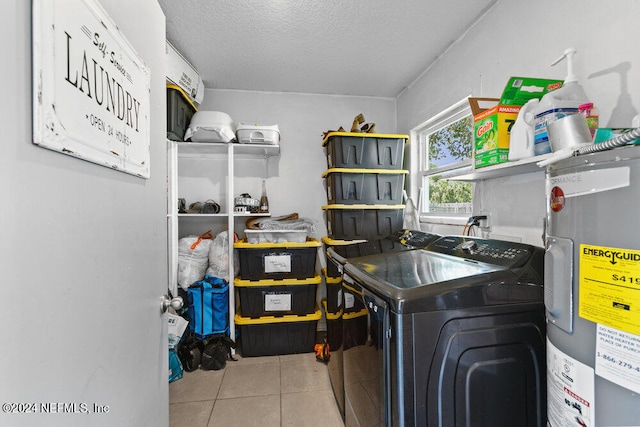 washroom featuring a textured ceiling, separate washer and dryer, light tile patterned floors, and electric water heater