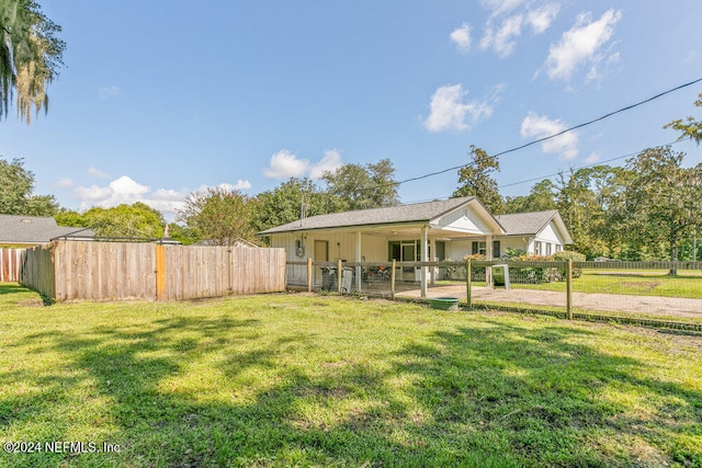 view of front of property with a front yard and a patio area