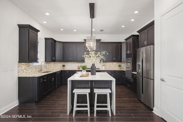 kitchen with dark hardwood / wood-style flooring, sink, a center island, and appliances with stainless steel finishes