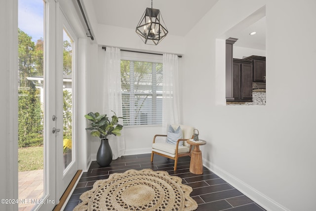 sunroom / solarium with an inviting chandelier