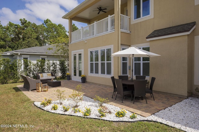 rear view of property with french doors, an outdoor hangout area, ceiling fan, a balcony, and a patio area