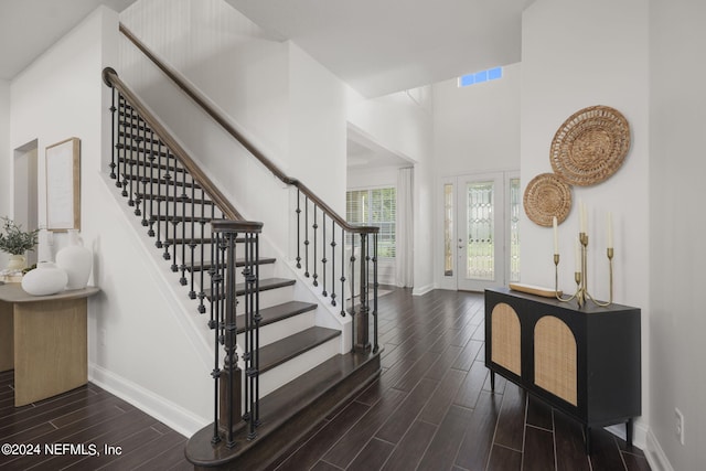 entrance foyer with a high ceiling and dark hardwood / wood-style flooring