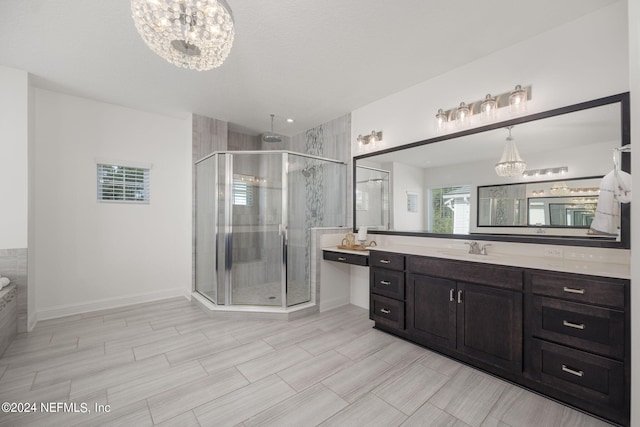 bathroom with a notable chandelier, a shower with door, and vanity