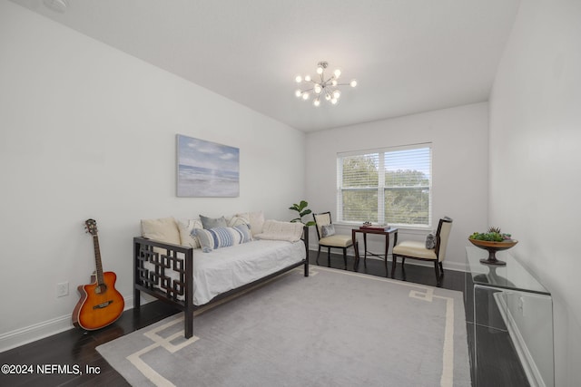 bedroom with dark hardwood / wood-style floors and an inviting chandelier