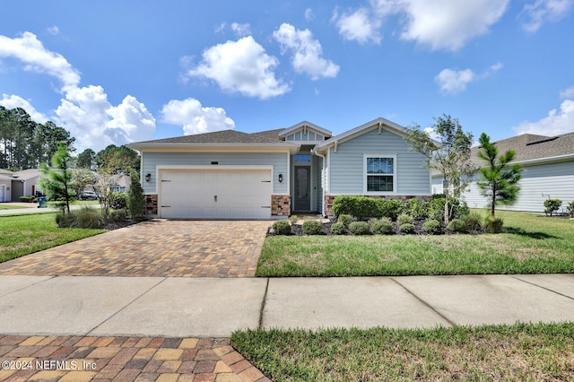 view of front of house with a garage and a front lawn