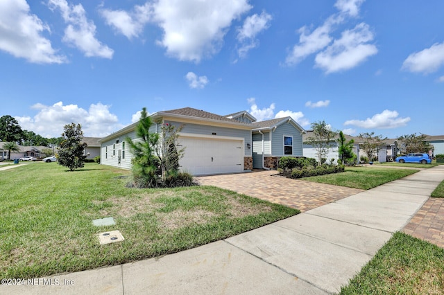 ranch-style home featuring a garage and a front yard