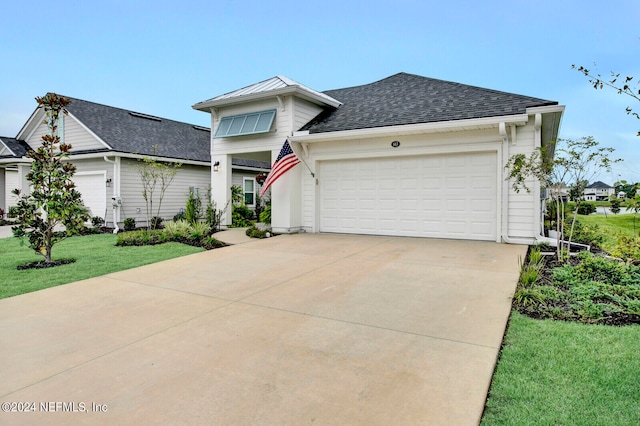 view of front of property featuring a garage and a front lawn