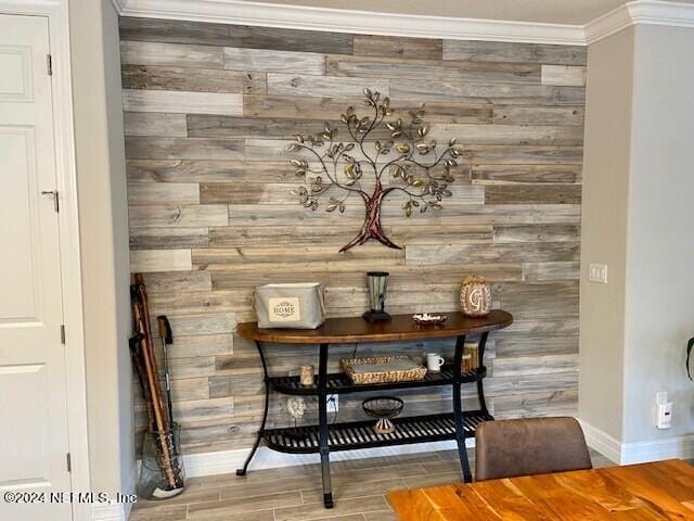 room details with ornamental molding and wooden walls