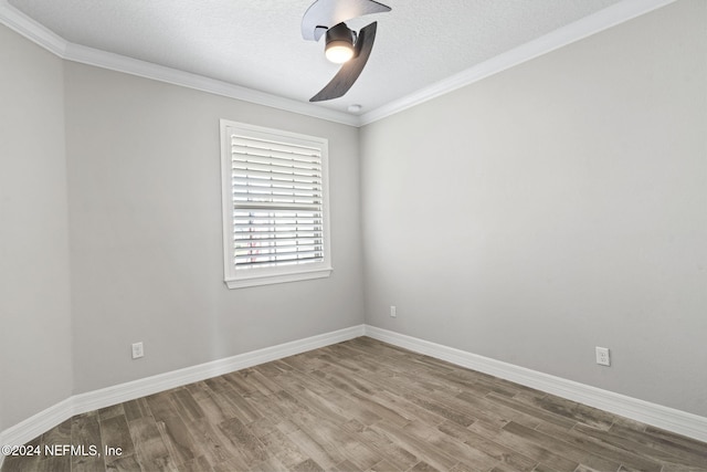 empty room with ceiling fan, wood-type flooring, crown molding, and a textured ceiling