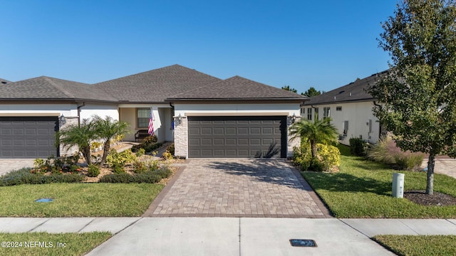 view of front of house featuring a front lawn and a garage