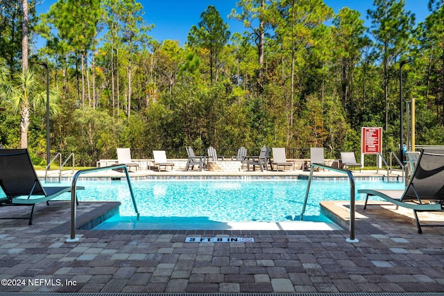 view of swimming pool with a patio