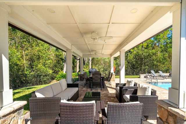 view of patio with an outdoor hangout area, ceiling fan, and a fenced in pool