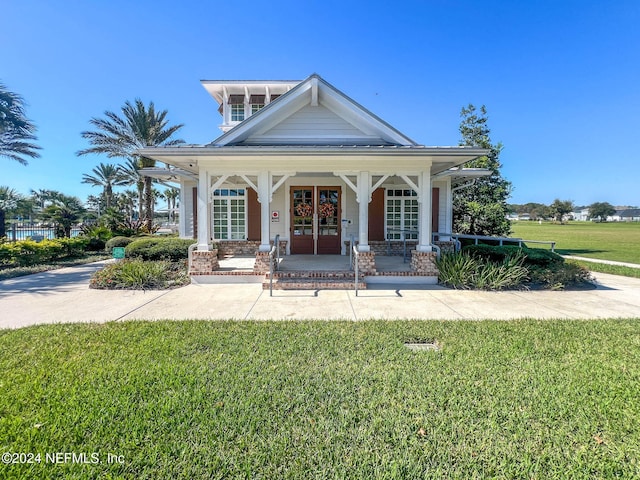 view of front of house with a porch and a front lawn