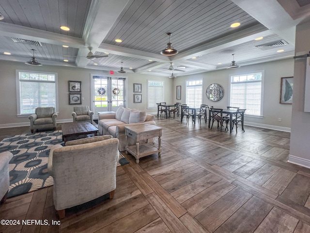 living room with beamed ceiling and plenty of natural light