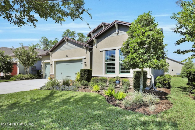 view of front of home featuring a front yard and a garage