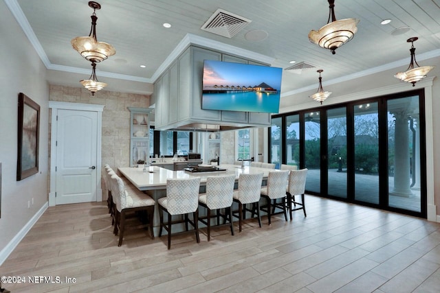 dining area featuring light wood-type flooring, ornamental molding, and wooden ceiling